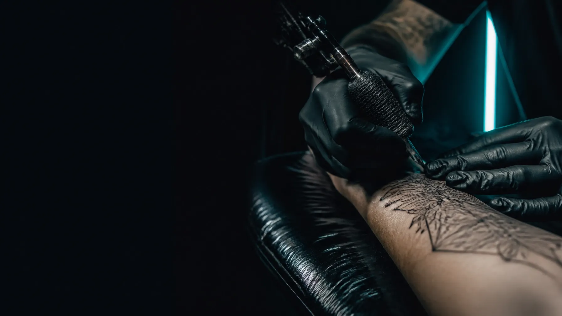 Artist tattooing a fine-line piece in the New Era Ink studio